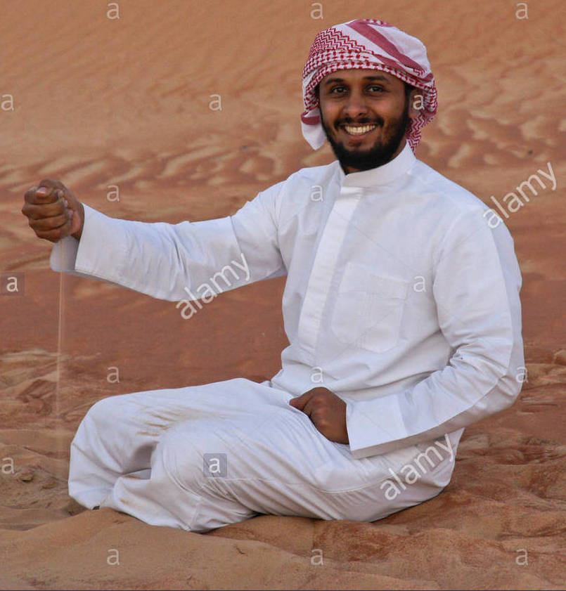 arab-man-in-traditional-dress-sitting-in-sand-dunes-of-liwa-abu-dhabi-EF8FD9.jpg