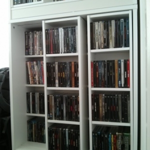 224 Steelbooks front and behind, some DVDs on top shelf behind